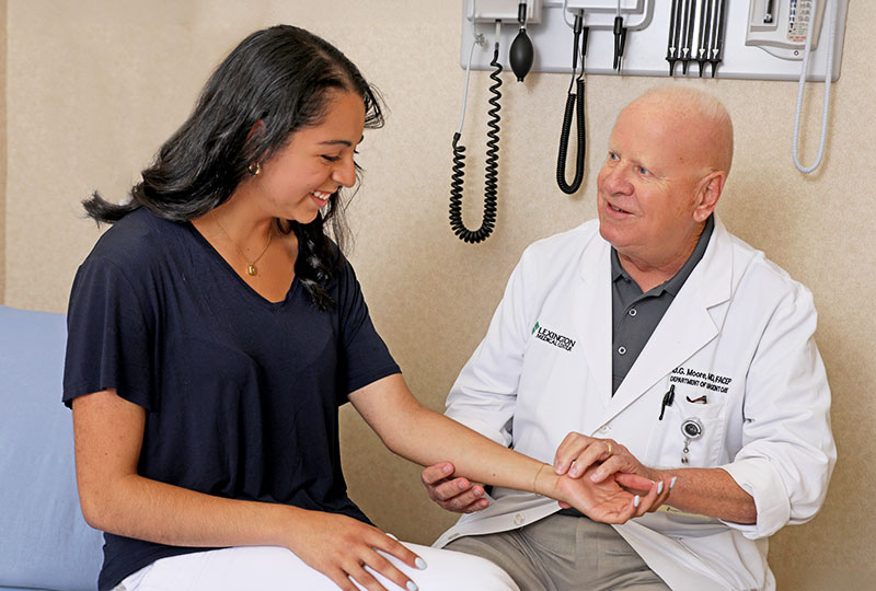 A doctor examines a patient's wrist.