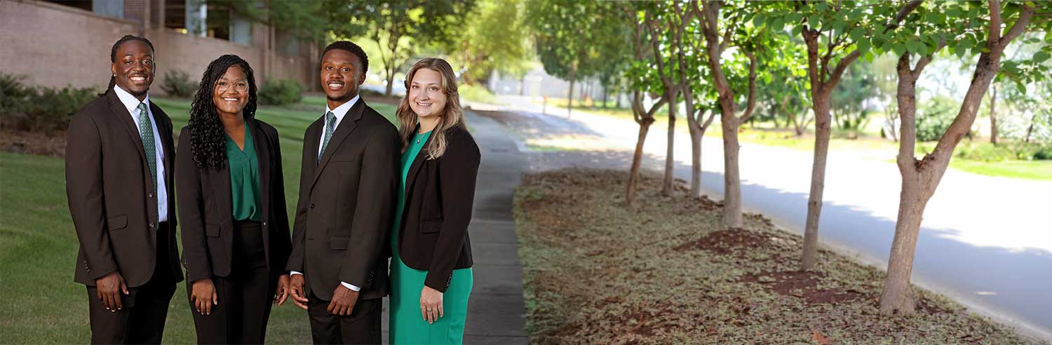A group of smiling administrative fellows dressed in business attire.