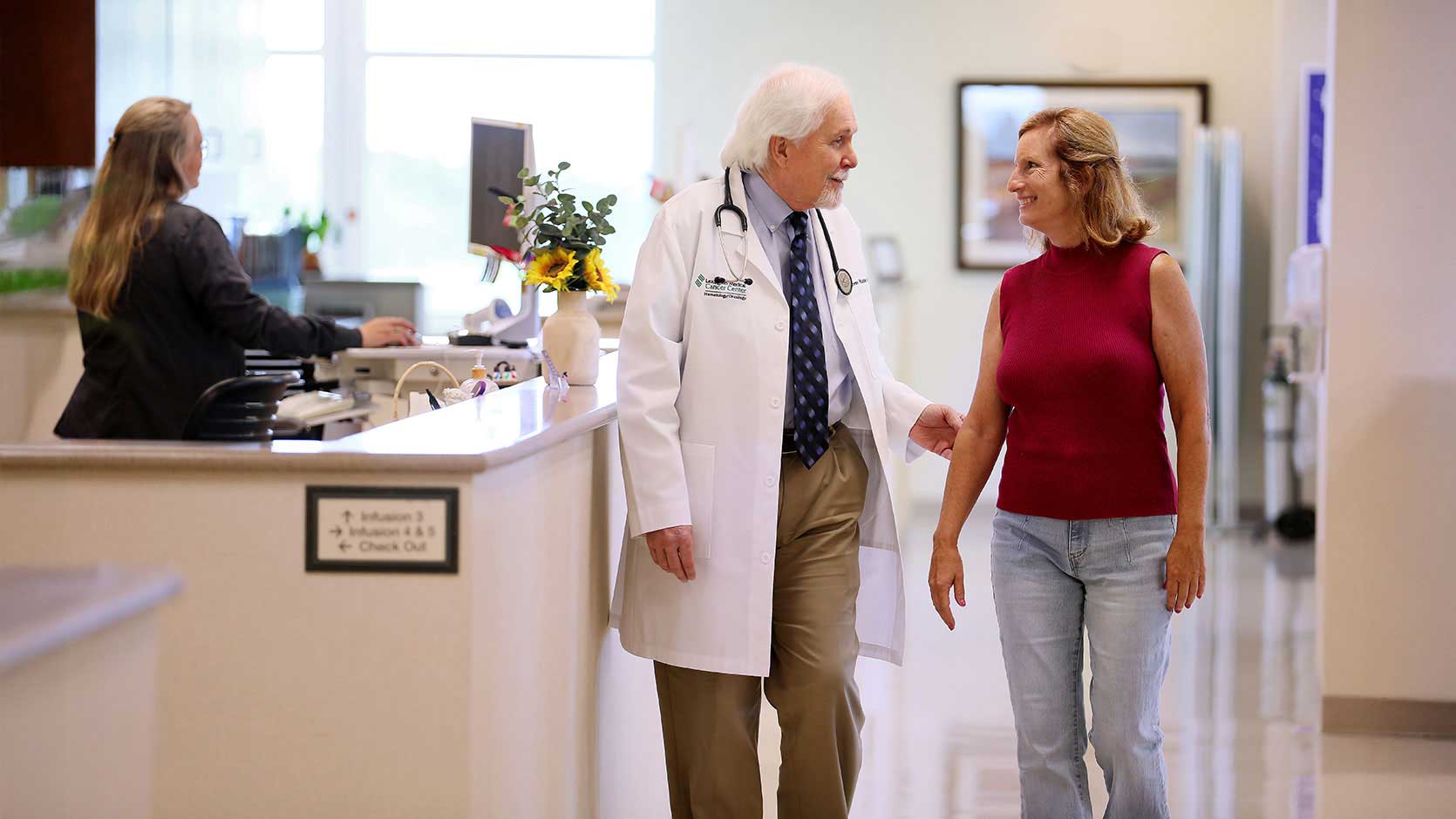 Image of a doctor walking with a patient