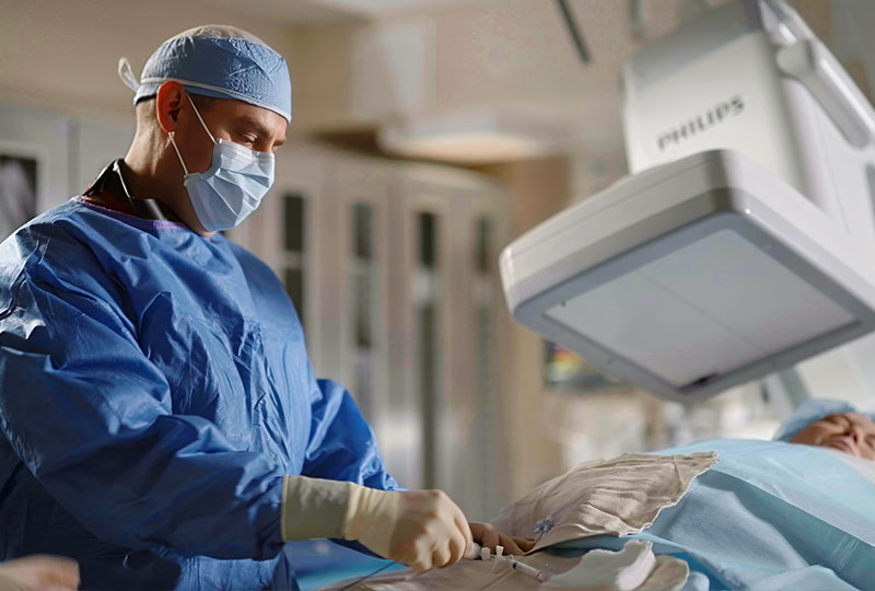 A doctor performing surgery on a patient. 