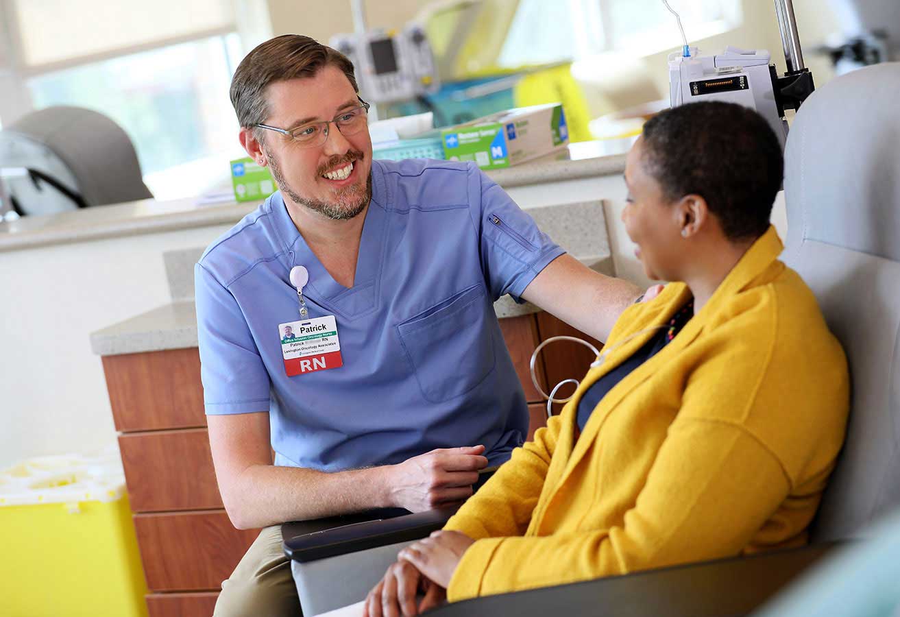 Registered nurse smiling with a patient.