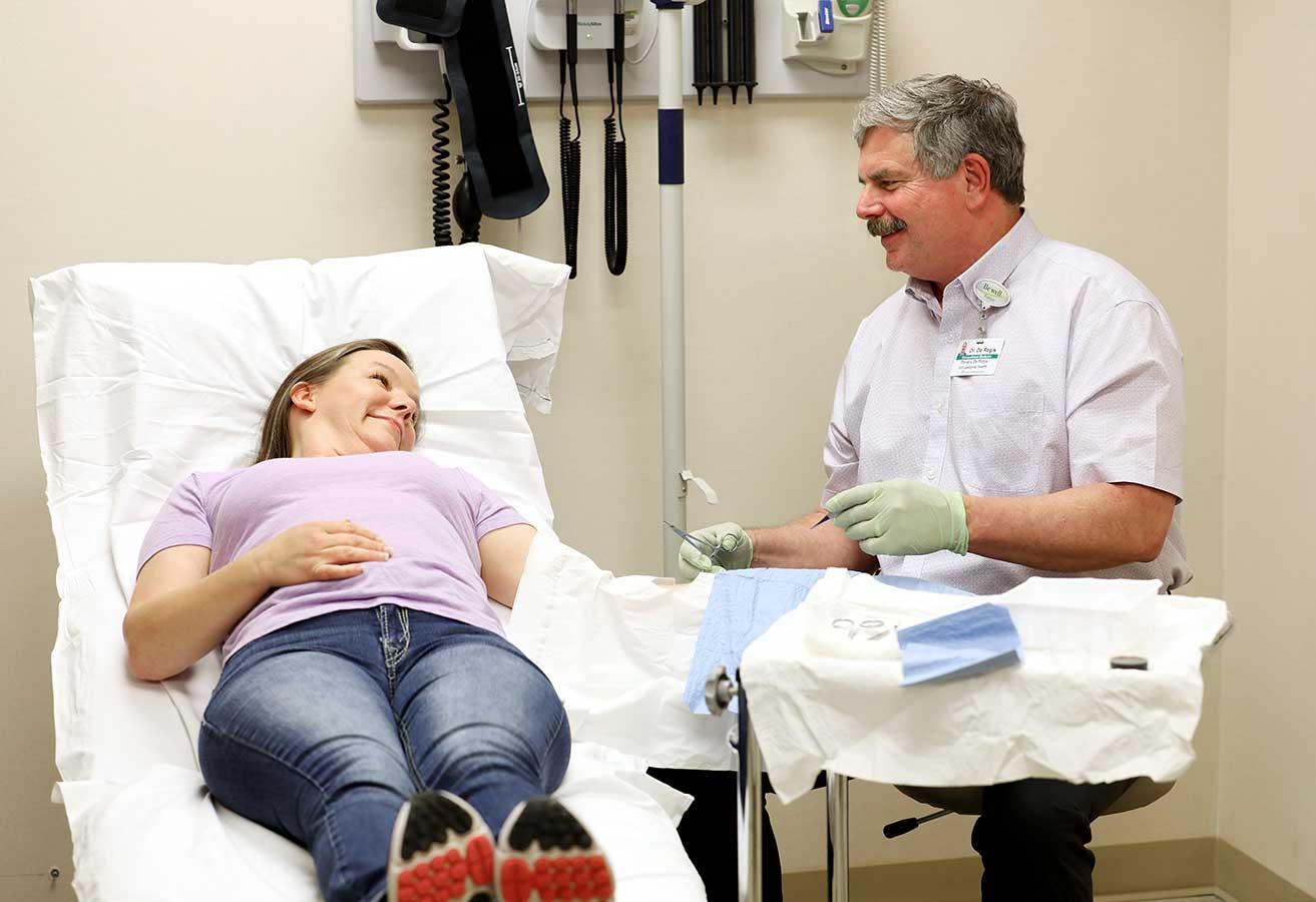 An occupational health doctor treating a smiling patient.